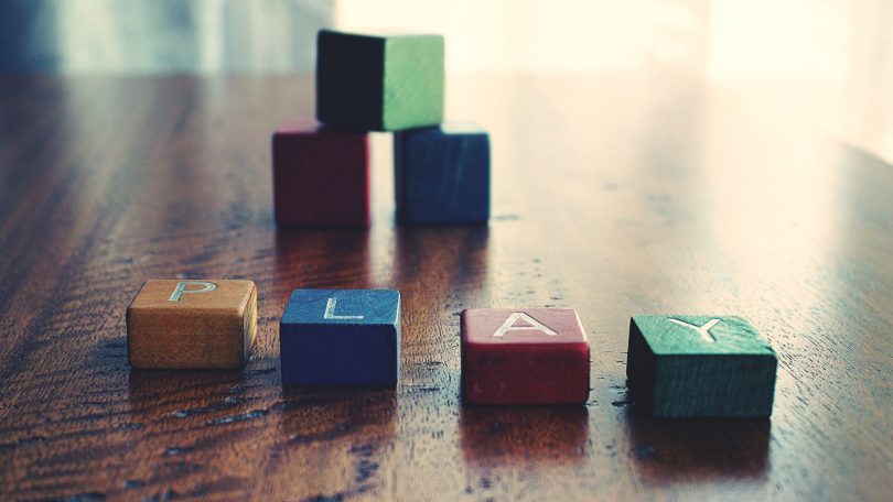 Play spelled as a word with colored blocks