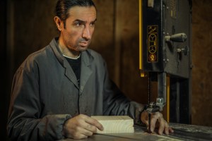 working man operating a bandsaw in a technical educational reform movement