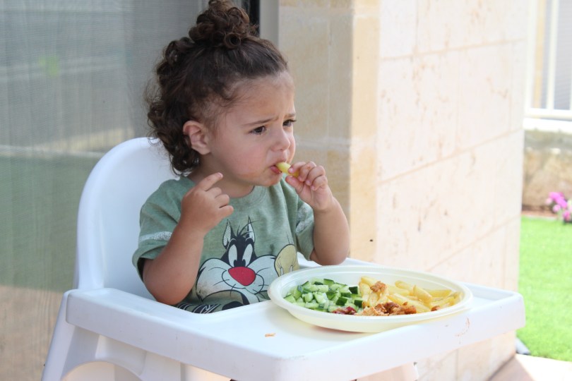 child eating varied meal